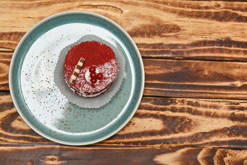 The cake on ceramic plate in turquoise with a sprinkling of chocolate and the reflection of light.