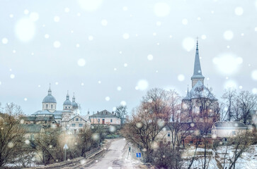 Fototapeta na wymiar Rural winter landscape of the town of Strusiv in Ukraine. Spiers of Orthodox and Catholic Churches