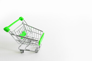 Shopping cart on white background. Small miniature shop trolley with space for your text. Copyspace mock up banner