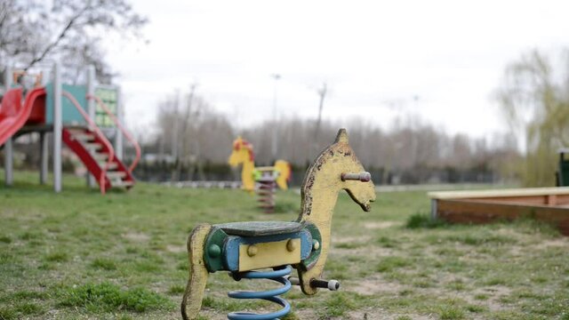 horse spring swing alone in an outdoor park close for the lockdown of the city for pandemic virus emergency alert