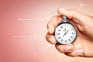 Silver classic stopwatch in the human hand
