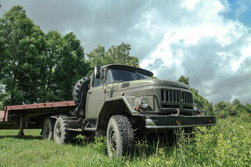 Old truck in very poor condition. A car stands in nature like abandoned metal rubbish. Stock photo background for design.