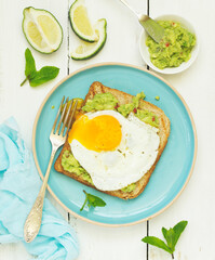 Toast with guacamole and egg for breakfast. Selective focus