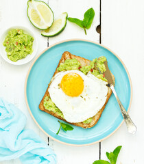 Toast with guacamole and egg for breakfast. Selective focus