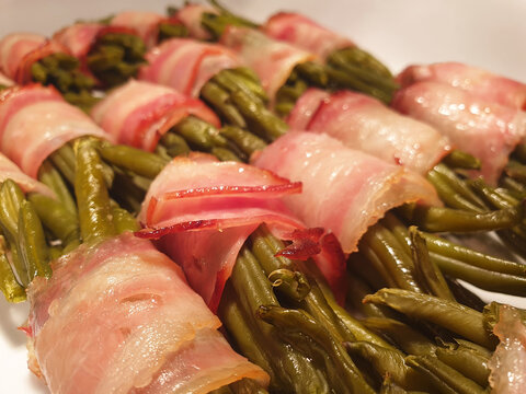 Light appetizer for a buffet of string beans ( fagiolini ) wrapped in bacon.