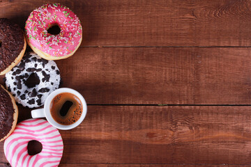 Assorted donuts and black coffee cups on brown wooden table. Top view, copy space. Bakery, coffee shop menu, breakfast, break concept