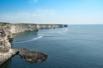 Beautiful view of the rocky coast of the blue sea on a sunny day - Image