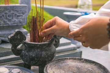 close-up of a woman hand holding incense. Concept of spiritual and religious