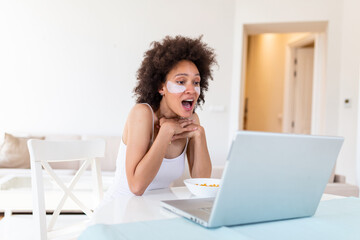 Photo of young lady in the morning browsing notebook watch thriller movie freelancer have breakfast eat cereal corn flakes stay home distance remote work quarantine indoors