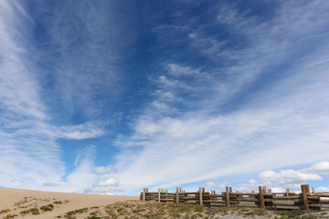 Wooden fence on the viewpoint around Crater Lake in summer with blue sky and cloudy.