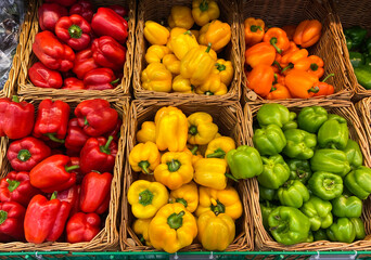 wicker basket of bell peppers on the store counter. farmers market fresh vegetables natural products
