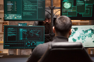 Two male hackers hacking into bank to steal credit card identity. Hackers technology.
