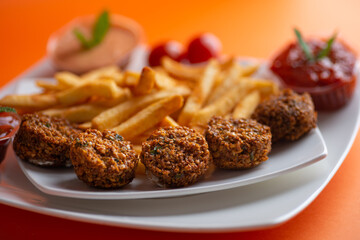 Falafel , middle eastern deep fried chickpea balls with french fries 