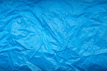 Crumpled blue wrapping paper as abstract background, texture