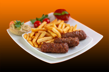 Traditional Romanian Dinner With Meatballs Or Mici And French Fries