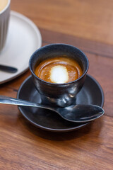 Macchiato in black cup