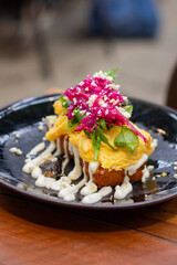 Potato hash with scrambled eggs, cheese and sauerkraut