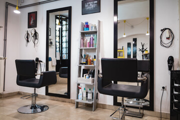 Empty hair salon interior with chairs and mirrors.