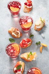 Party time concept Fruit bruschetta with summer drink top view Delicious appetizer snack