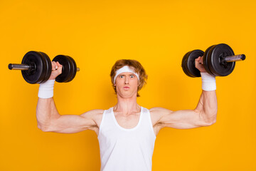 Fototapeta na wymiar Close-up portrait of his he nice attractive sportive funky muscular nerd guy sportsman lifting heavy barbell physical intense isolated over bright vivid shine vibrant yellow color background