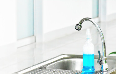 New normal, Hand soap bottles on stainless steel sink for hand washing before and after learning in class of Thai students at school to prevent and protect germs and coronavirus or covid-19.