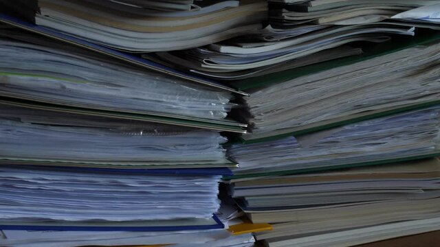 working in office with documents, binders full of documents