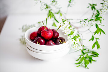 fresh Cherry on white bowl with flowers