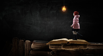 Girl walking with book around her