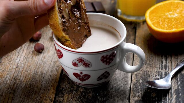 woman eating bread with nutella and milk- breakfast