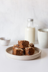Homemade chocolate vegan brownies with coconut milk on white table