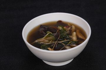 Thai style soup with meat and mushrooms