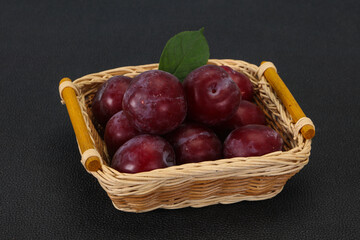 Plum heap in the wooden basket