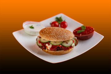 Falafel vegetarian burger with vegetables isolated on white plate