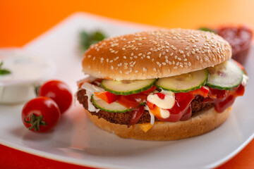 Falafel vegetarian burger with vegetables isolated on white plate