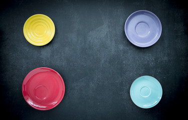 colorful round dishes on dark blue background