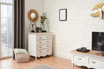 Home living room corner with classic drawer and cabinet style. Brick wall background.
