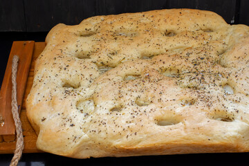 focaccia dough in a baking dish. Traditional Italian Focaccia with rosemary