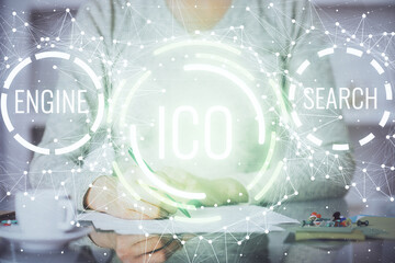 Cryptocurrency hologram over woman's hands writing background. Concept of blockchain. Multi exposure