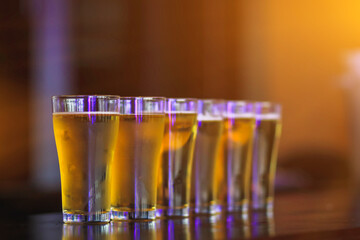 Soft Light And Smooth Focus,The young woman poured beer in an Arrange of beer glasses on the bar counter to serve customers who were celebrating success. The idea of drinking alcohol or beer to relax.