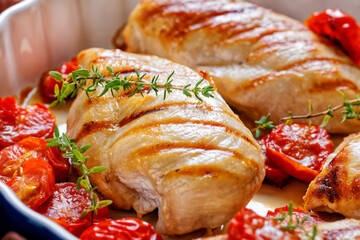 grilled chicken breasts with tomatoes, top view