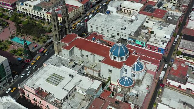 Immaculate Conception Cathedral. Drone shot, orbit motion to reveal beauty of Tepic Cathedral. Traffic Jam on busy street. Nayarit, Mexico.
