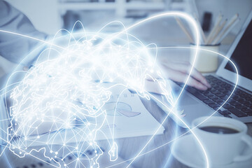 Multi exposure of businessman working on laptop on background. International business hologram in front. Concept of success.