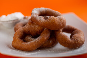 Yummy yellow dougnuts with granulated sugar.