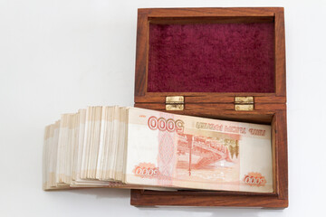 Russian banknotes of five thousand rubles in large quantities in a wooden box