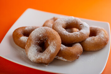 Yummy yellow dougnuts with granulated sugar.