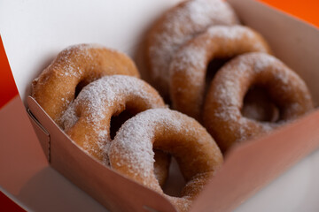 Yummy yellow dougnuts with granulated sugar.