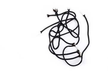Paracord on a white background. Black ropes lie in a pile on the right on a white background. Paracord with disheveled, bad edges
