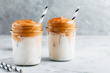 Dalgona coffee. Iced coffee with creamy whipped foam and almond milk.