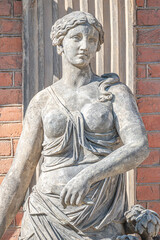 Obraz premium Old statue of a sensual Renaissance Era woman in the central city park of Potsdam, a German town of statues and sculptures, Germany