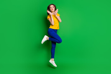 Full length body size view of her she nice attractive lovely lovable funky cheery slim fit girl jumping having fun sending air kiss isolated bright vivid shine vibrant green color background